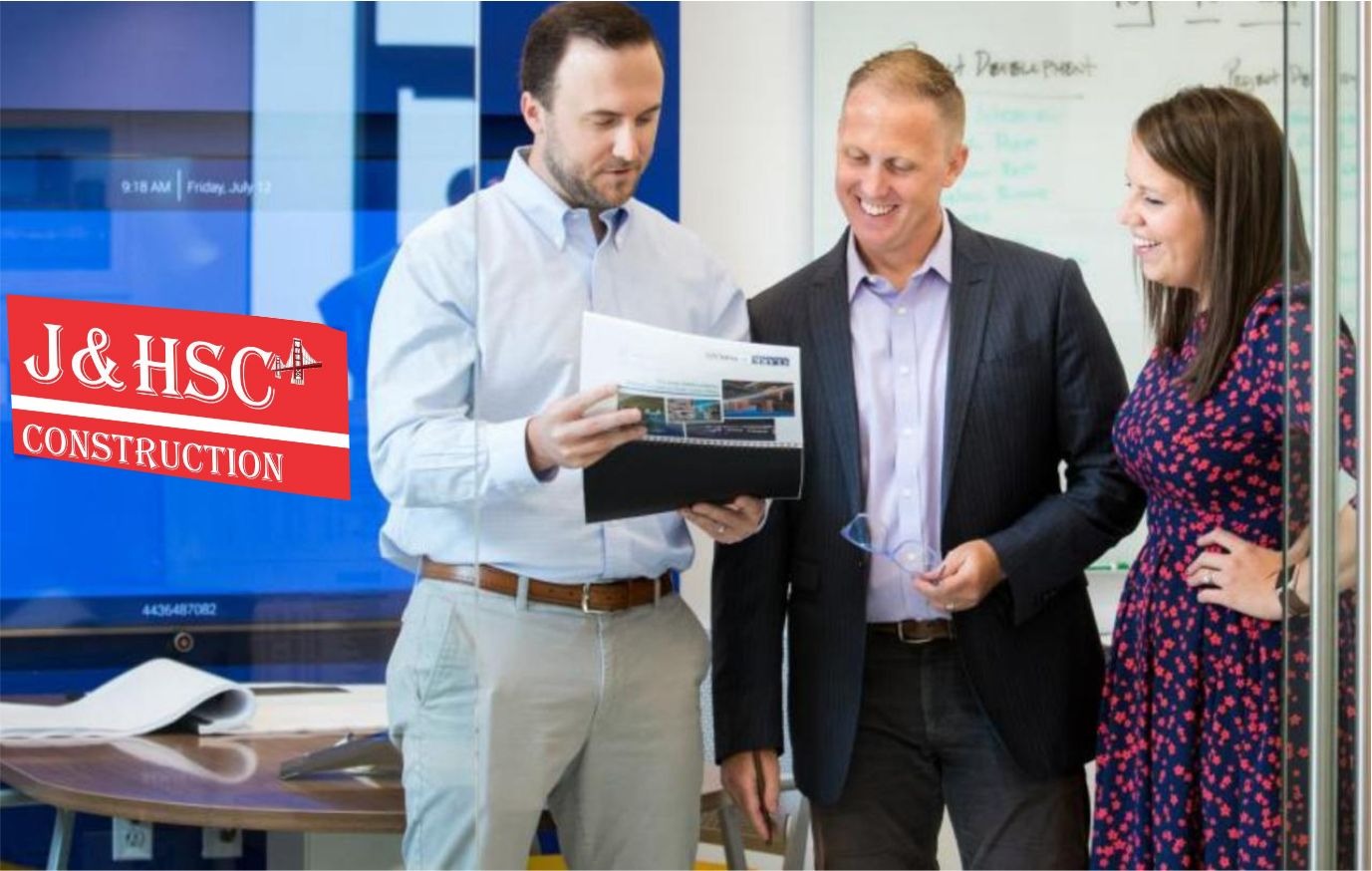 Three team members work together in a J&H Signature Construction group office